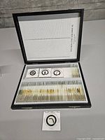 Open leatherette case showing rows of prepared slides in plastic rack