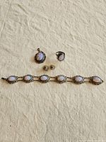 Group view of opal bracelet, ring, earrings, pendant