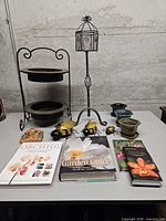 Group shot showing plant stand, pots, metal display, bees, books