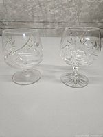 Front view of both pinwheel-patterned brandy snifters