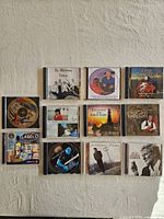 Overview of twelve music CDs arranged on a surface