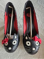 Front view of both cat-face heels with red bows