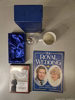 Group shot of all items: mug, bell, presentation box, magazine, DVD