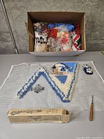 Box with assorted yarn loops in bags and skeins