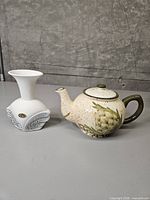 Teapot and vase side by side showing overall size and style