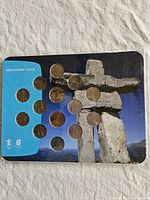 Front of sealed coin set showing 12 of the quarters and Inukshuk artwork
