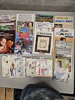 Overview of all pattern booklets and sewing pattern envelopes on table