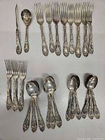 Full layout showing all 22 matched silver-plate pieces