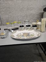 Overview showing turkey platter, CorningWare mugs, candy jar, Tupperware jars, foil pan