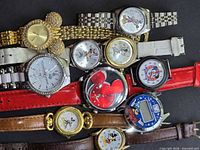 All ten Mickey Mouse watches laid out showing variety of styles and bands