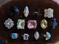 All 13 rings arranged on display showing variety of stones and settings