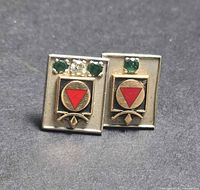 Front view of both tack pins showing gemstones and logo