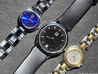 Three ESQ by Movado wristwatches laid out side by side showing dials and bracelets
