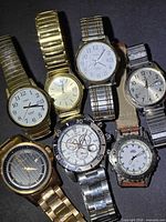 Group shot of all seven watches showing overall variety and condition