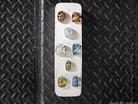 All eight Murano glass rings on display card