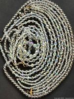 Coiled view of all iridescent glass bead necklaces