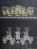 All sixteen glasses grouped on two shelves