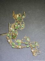 Overview of necklace and bracelet showing jade cabochons and gold-filled links
