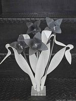 Full view of lucite floral sculpture showing leaves, flowers and base