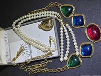 Lot overview with Nolan Miller box, two pearl strands, pendant and KJL cabochon necklace