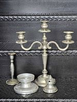 All five pewter candle accessories grouped