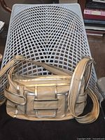 Full view of Pierre Hardy beige leather messenger bag on chair