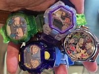Front view of four Rugrats watches showing different cases and dials