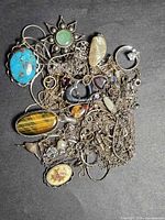 Pile of sterling silver necklaces with assorted pendants