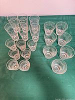 All glasses arranged showing three size groups and consistent etched laurel leaf band
