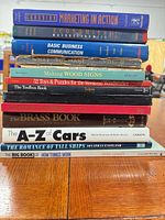 Stack of 13 assorted books showing spines and titles