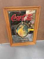 Front view showing Coca-Cola mirror sign, frame, graphic details
