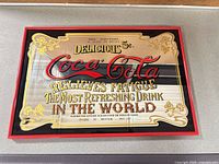 Front view of framed Coca-Cola sign showing full artwork and frame