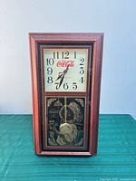 Front view showing entire clock, wood-look frame, upper dial and lower panel