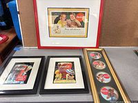 All four framed Coca-Cola advertising pieces