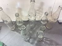 Full group of seven assorted Coca-Cola bottles