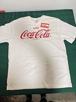 Front view showing Coca-Cola logo graphic and overall condition