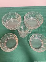 Group shot of four bowls and one creamer