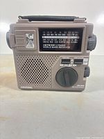 Front view of Grundig FR-200 radio showing controls, tuning scale, flashlight lens