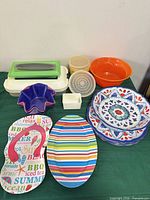 Lot overview showing all plastic plates, bowls, platters and containers