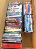 Open box showing two tall stacks of DVD cases