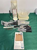 All utensils, storage containers and boxed straw set laid out on table