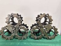 Front view of both wine bottle holders showing gear design and bolt details