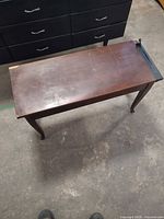 Full view of piano bench top and legs