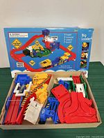 playset parts laid in box bottom with outer box back panel visible