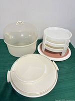 Group shot showing cake carrier, tiered serving stand and round storage container