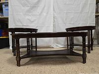 Front view of coffee table centered between two matching end tables