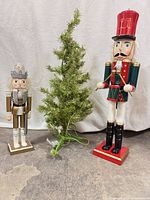 Group shot of both nutcrackers and one tinsel tree