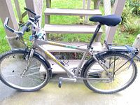 Full left-side view of bicycle showing frame, wheels, rack and fenders