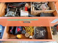 Drawer with tool bag, yellow rope, work light, black cables, boxed fasteners
