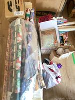 Overview of lot with wrapping paper rolls, bows, garland and CDs